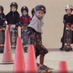 Students wearing headscarves and helmets learn to navigate traffic cones in a scene from the Oscar-winning documentary, "Learning to Skateboard in a Warzone (If You're a Girl)." A&E IndieFilms/ Screenshot by NPR