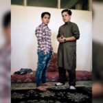 Ali, 14, wears jeans and a shirt while her sister Setar, 16, wears a traditional outfit for men, in Kabul, in a practice known as "bacha posh,”