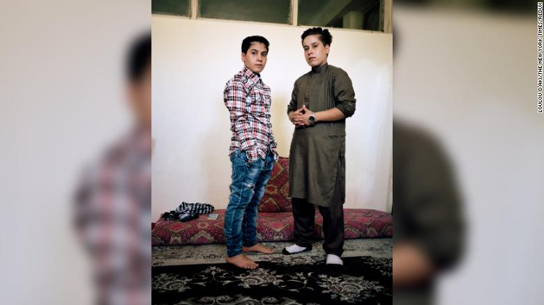 Ali, 14, wears jeans and a shirt while her sister Setar, 16, wears a traditional outfit for men, in Kabul, in a practice known as "bacha posh,”