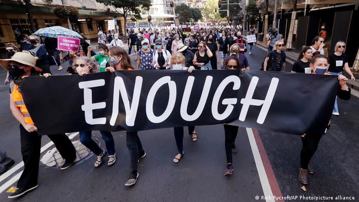 Thousands of people with placards and banners rally in Sydney demanding justice for women