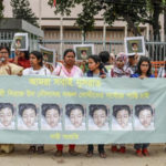 Bangladeshi women hold banners and photographs of schoolgirl Nusrat Jahan Rafi at a protest in Dhaka [AFP]