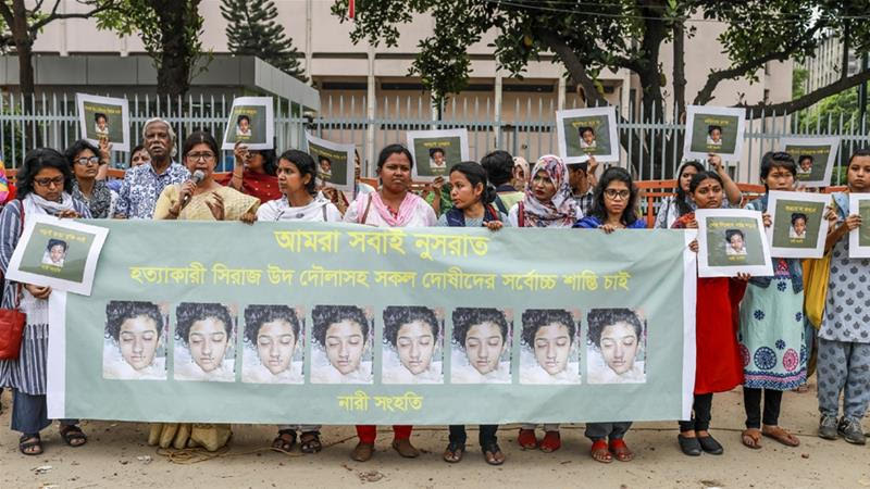 Bangladeshi women hold banners and photographs of schoolgirl Nusrat Jahan Rafi at a protest in Dhaka [AFP]