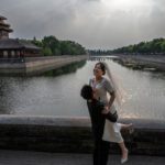 A Chinese couple celebrating their wedding, outside the Forbidden City in Beijing.Credit...Kevin Frayer/Getty Images