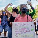 Women protest against violence against women with a sign reading 'Sexual violence as a war weapon still exists in Colombia' in Medellin, Colombia, on June 19, 2020, amid the new coronavirus pandemic [Photo by Joaquin Sarmiento/AFP]