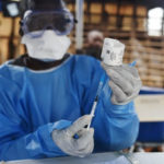 A health worker prepares to administer Ebola vaccine outside a house in the village of Mangina, in the Democratic Republic of the Congo’s North Kivu province. Photograph: Olivia Acland/Reuters