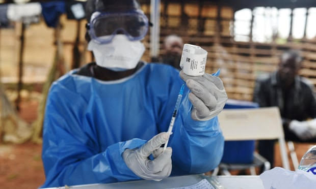 A health worker prepares to administer Ebola vaccine outside a house in the village of Mangina, in the Democratic Republic of the Congo’s North Kivu province. Photograph: Olivia Acland/Reuters