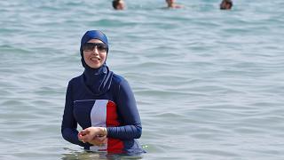 Karima, wearing a full-body burkini swimsuit, swims in Cannes after the call to support the wearing of burkinis by businessman and political activist Rachid Nekkaz. - Copyright ERIC GAILLARD/REUTERS