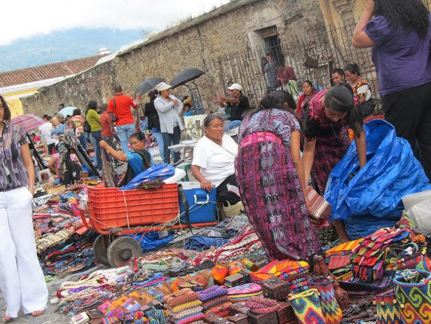 Indigenous women sell handicrafts at a street market in the tourist city of Antigua, Guatemala. Due to the continuing lack of decent employment for women in the region, many of them become street vendors, swelling the ranks of the informal economy. Credit: Mariela Jara/IPS