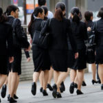 Female office workers wearing high heels, clothes and bags of the same color make their way at a business district in Tokyo, Japan, June 4, 2019. (REUTERS/Kim Kyung-Hoon)