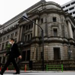 A man wearing a protective mask walks past the headquarters of Bank of Japan amid the coronavirus disease (COVID-19) outbreak in Tokyo, Japan, May 22, 2020. REUTERS/Kim Kyung-Hoon