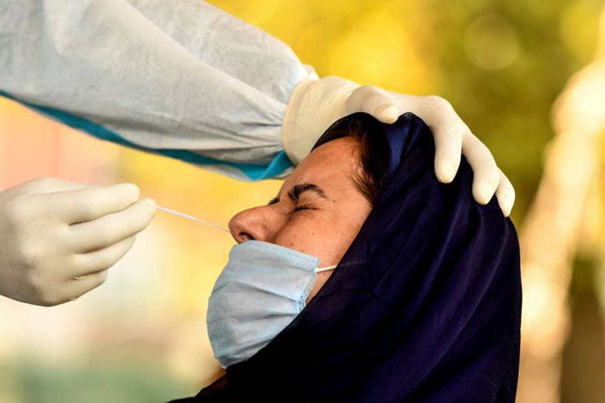A woman reacts as a medical worker collects a swab sample for a Rapid Antigen Test for the novel coronavirus in Jammu & Kashmir, on Sept. 11. TAUSEEF MUSTAFA/AFP/GETTY IMAGES