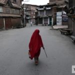 A woman walks through a deserted lane in August 2019, after India’s government moved to strip Kashmir’s semi-autonomous status and imposed a military lockdown. (Adnan Abidi/REUTERS)