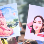 Protesters hold up pictures of Aizada Kanatbekova at a demonstration in Bishkek after her death.