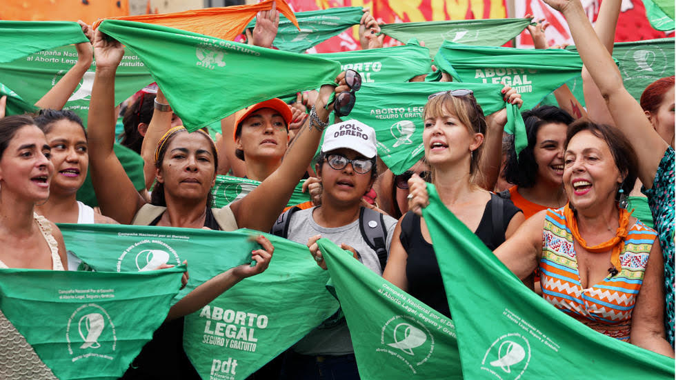 Women holding green handkerchiefs calling for the legalization of abortion participate in a protest marking International Women's Day, in Buenos Aires, Argentina March 8, 2020. © REUTERS/Florencia Guzzetti