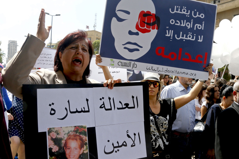 Activists carry placards calling for justice for the women killed by domestic violence in Lebanon, in Beirut May 30, 2015. The text on the placards read in Arabic: (R) "He who kills the mother of his children, we will not accept but to execute him." and "Justice for Sarah Al-Amin." REUTERS/Mohamed Azakir
