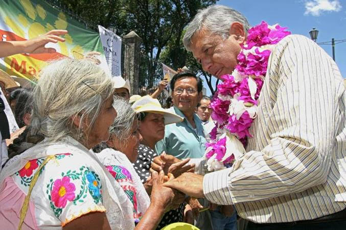 Andrés Manuel López Obrador, then a presidential candidate in Mexico, shakes hands with supporters during his campaign in the North Sierra of the state of Puebla. RONALDO SCHEMIDT/AFP VIA GETTY IMAGES