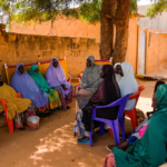 Fatouma speaks to mothers in a suburb of Niamey, the capital of Niger, in September, trying to convince them to heed her message: Let your girls grow up.