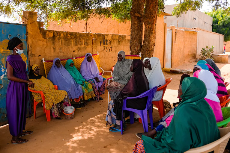Fatouma speaks to mothers in a suburb of Niamey, the capital of Niger, in September, trying to convince them to heed her message: Let your girls grow up.