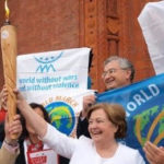 Mairead Corrigan Maguire, Nobel Peace Laureate and endorser of the Women's Appeal, holding the nuclear abolition flame outside a Nobel Peace Summit meeting. Photo credit: Alyn Ware