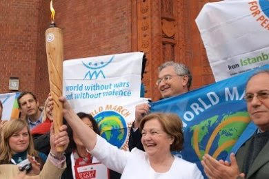 Mairead Corrigan Maguire, Nobel Peace Laureate and endorser of the Women's Appeal, holding the nuclear abolition flame outside a Nobel Peace Summit meeting. Photo credit: Alyn Ware