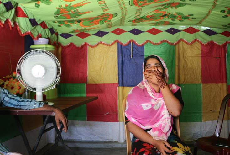 Cox’s Bazaar-Bangladesh - Romida Begum covers a smile as she meets with TNH after winning the job of camp leader in an election held in June 2018. Polls have taken place in four of the 34 Rohingya refugee camps.