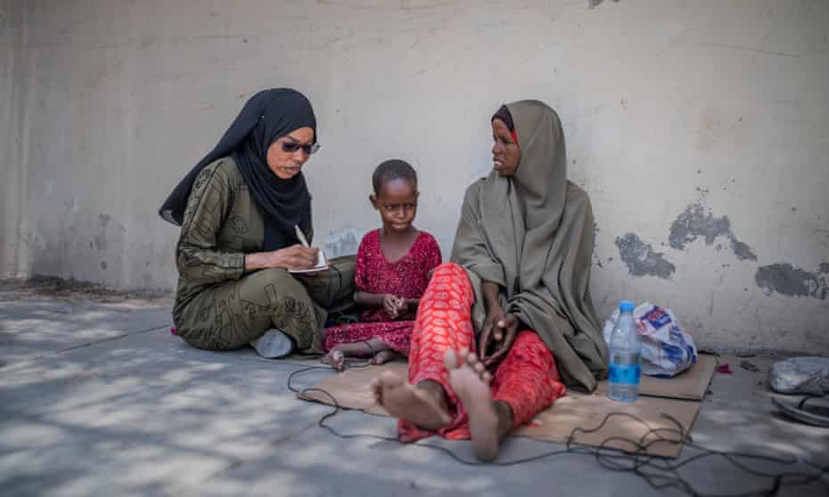 Nasrin Mohamed Ibrahim interviewing for Bilan. ‘Men think you should come in, read the news and go home,’ she says of attitudes from male colleagues in the media. Photograph: Bilan