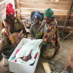 A Tanzanian family has just received a maternity package. The mother, an older child, and the grandmother, with a 1-month-old infant sleeping in a box. In mountainous areas, the temperature can fall below zero during the night. Photograph: Annika Varpe