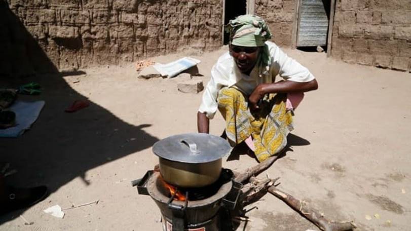 A woman using an energy efficient cookstove in Tanzania. Photo by: Russell Watkins / DFID / CC BY