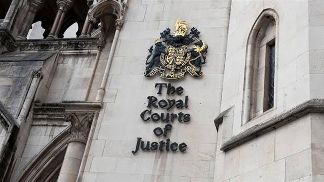 The coat of arms of the Royal Courts of Justice is pictured in central London.The building houses both the High Court and the Court of Appeal [Will Oliver/EPA]