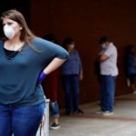 A woman who lost her job waits in line to file for unemployment following an outbreak of the coronavirus, at an Arkansas Workforce Center in Fort Smith, Ark., April 6, 2020. --Nick Oxford—REUTERS